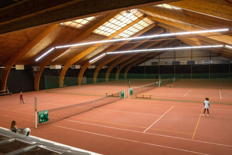 Campi da tennis al coperto con soffitto in legno al Camping GT Keiheuvel, parco vacanze ad Anversa, Belgio.