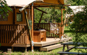 Tienda glamping safari La Vida en Resort de Parel, Países Bajos, con terraza y entorno natural verde.