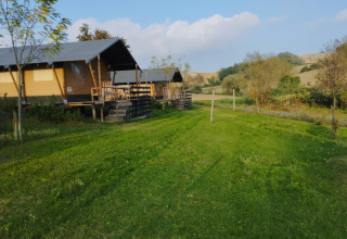 Camping Suasa holiday park in Marche, Italy, features cozy canvas lodges and lush green countryside views.