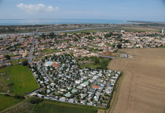 Vista aérea del parque vacacional Flower Camping Le Pré des Sables en Pays de la Loire, Francia, cerca del mar.