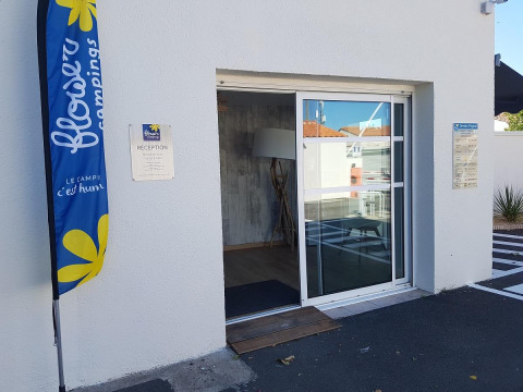 Entrance and reception of Flower Camping Le Pré des Sables holiday park in Pays de la Loire, France.