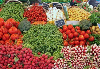 Étalage coloré de légumes frais au marché de Flower Camping Le Pré des Sables, Pays de la Loire.
