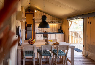 Interior view of a luxury safari tent suite at Safarilodge Impala in Vakantiepark IJsselhof, Netherlands.