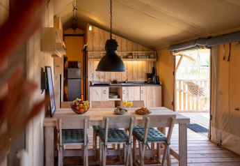 Interior view of a luxury safari tent suite at Safarilodge Impala in Vakantiepark IJsselhof, Netherlands.