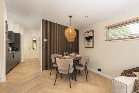Moderne eethoek in Loevestein Deluxe met hottub en sauna op Veluwepark de Bosgraaf, Nederland.