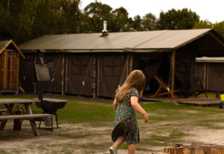 A child walks on tree stumps at Feather Down Het Keelven, a holiday park in North Brabant, Netherlands.