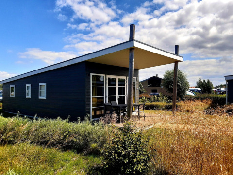 Moderne vakantiewoning met terras en grote ramen op Kompas Camping Nieuwpoort, West-Vlaanderen, België.