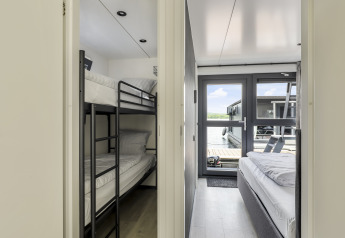 Vista interior de Houseboat Marina Mookerplas en Países Bajos con literas y vista al lago.