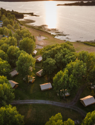 Aerial view of Huttopia Lac d'Aureilhan - Mimizan holiday park nestled by the lake in Nouvelle-Aquitaine, France.