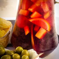 Karaffe mit Sangria mit Fruchtstücken, grünen Oliven und Chips in Guardiola de Berguedà, Barcelona, Spanien.