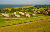 Aerial view of Vakantiepark IJsselhof holiday park in North Holland, featuring cabins and the sea.