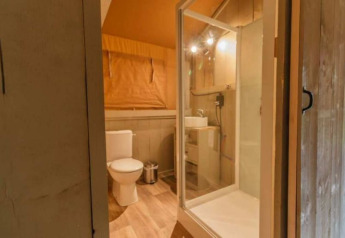 Badkamer met douche en toilet in een safaritent bij Parc Koudenburg in Nederland.