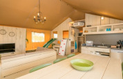 Interior of Safaritent Medley at Camping Goorzicht in the Netherlands with kitchen, dining, and lounge area.
