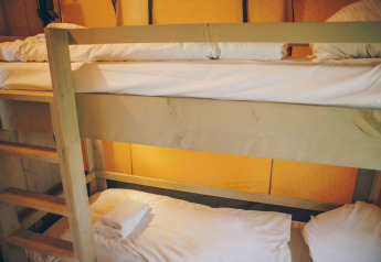 Stockbett mit weißer Bettwäsche im Safari-Zelt im Wilsumer Berge, Deutschland, gemütliches Ambiente.