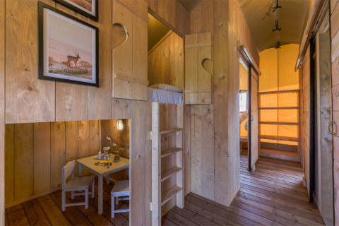 Interno della tenda Safarilodge Gazelle con letti a castello e angolo bambini nei Paesi Bassi.