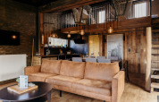 Cozy living area in Juttershut lodge at Duynpark Het Zwanenwater, Netherlands, featuring rustic wooden accents.