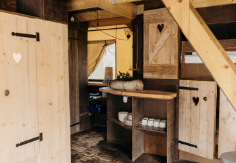 Rustic kitchen interior of a safari tent called Beach Lodge at Duynpark Het Zwanenwater, Netherlands.