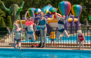 Children jumping into a pool with colorful inflatable hot air balloons at Camping Goorzicht, North-Holland, Netherlands.