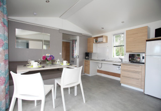 Bright mobile home Comfort Stacaravan PMR 29m2 with dining area and modern kitchen at Flower Camping Le Kerarno.