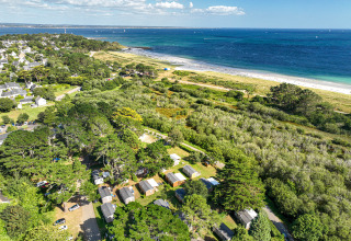 Aerial view of Flower Camping Le Vorlen holiday park in Brittany, France near the coast and lush greenery.