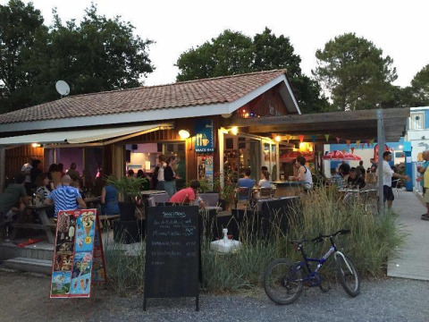 Vista nocturna de un animado bar en Flower Camping La Canadienne en Nouvelle-Aquitaine, Francia.