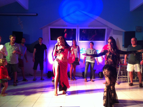 Holiday park guests enjoy a lively dance night with performers and audience at Flower Camping La Canadienne.
