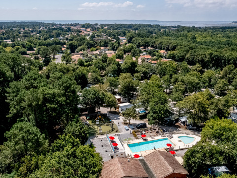 Aerial view of Flower Camping La Canadienne with swimming pool and trees in Nouvelle-Aquitaine, France.