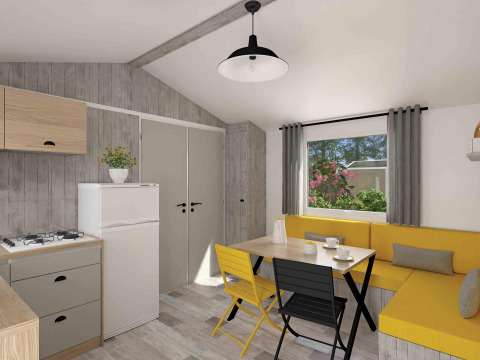 Alojamiento de glamping moderno con pequeña cocina, sofá amarillo en esquina, mesa y ventana.