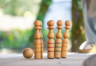 Wooden skittles and ball outdoors on a table at Flower Camping Monplaisir in Nouvelle-Aquitaine, France.
