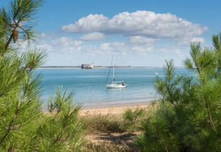 Udsigt til sejlbåd på havet fra stranden ved Flower Camping Monplaisir, Nouvelle-Aquitaine, Frankrig.