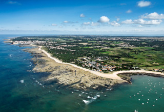 Aerial view of coastline and Flower Camping Monplaisir holiday park in Nouvelle-Aquitaine, France.
