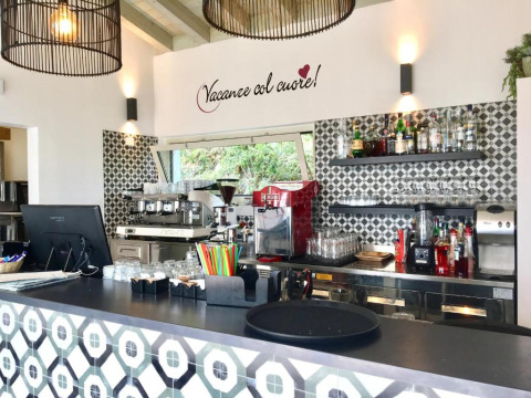 Bar cafetería moderno con decoración italiana y azulejos decorativos en Sivinos Camping Boutique, Lombardía, Italia.