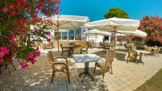Terrazza all'aperto al Sivinos Camping Boutique in Lombardia, Italia, con ombrelloni e fiori in fiore.