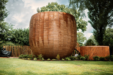 Unique round tiny house The Nutshell with outdoor hot tub and sauna at Den Blanken park, Netherlands.