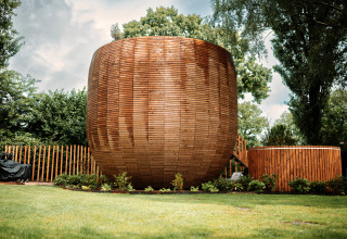 Unique round tiny house The Nutshell with outdoor hot tub and sauna at Den Blanken park, Netherlands.