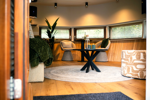 Cozy living area in The Nutshell tiny house with hot tub and sauna at Recreation Park Den Blanken, NL.