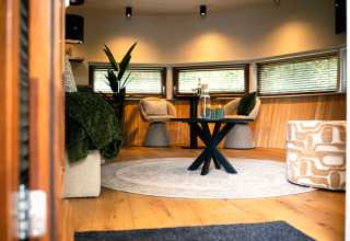 Cozy living area in The Nutshell tiny house with hot tub and sauna at Recreation Park Den Blanken, NL.