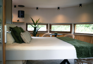 Moderne soveværelse i tiny house The Nutshell med grønne detaljer på Recreation Park Den Blanken, Holland.