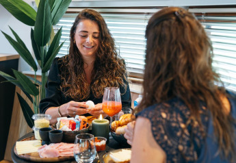 Due donne fanno colazione a un tavolo in The Nutshell al Recreation Park Den Blanken nei Paesi Bassi.