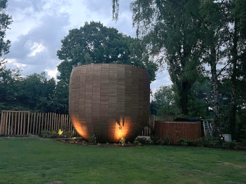 Unique tiny house The Nutshell with illuminated exterior, hot tub and sauna at Den Blanken, Netherlands.