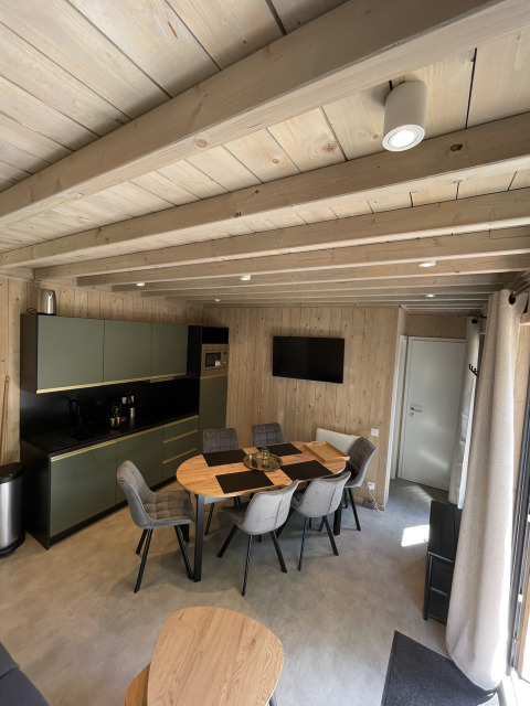 Modern lodge with kitchen and dining area at Ecolodge, Hameau de la Semois in Belgium, pet-friendly.