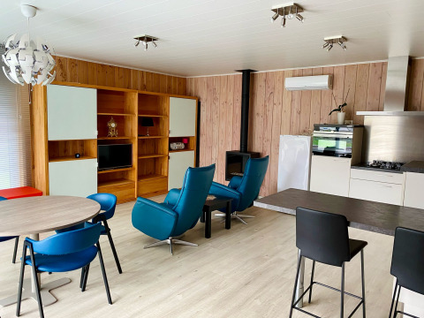 Bright living area in a Chalet at Familiepark Goolderheide, Belgium, with modern decor, kitchen, and seating.