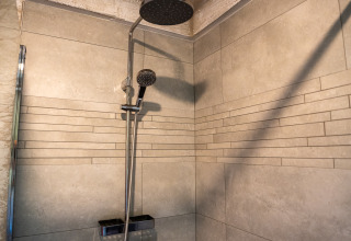 Modern shower with rainfall showerhead and hand shower in Hobbit huisje, Familiepark Goolderheide, Belgium.