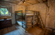 Cozy room with bunk beds and wooden decor at Hobbit huisje in Familiepark Goolderheide, Belgium.
