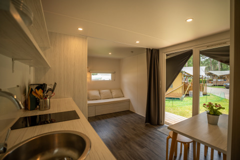 Interior view of the Cooc tent deluxe safari tent at Familiepark Goolderheide, Belgium, showing modern amenities.