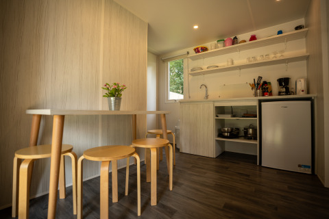 Modern kitchen and dining area in Cooc tent deluxe at Familiepark Goolderheide, Belgium, bright interior.