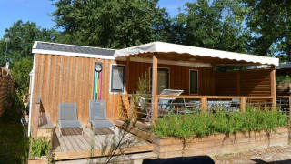 Outdoor view of Stacaravan Premium Clim at Flower Camping La Canadienne featuring a wooden deck and sun loungers.