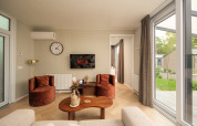 Stylish living room at Rosendael Comfort with Netflix, cozy chairs and garden view, Veluwepark de Bosgraaf.