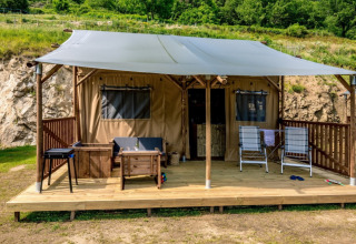 Safari tent Lodgetent with sanitary facilities at Camping l'Ardechois in France, wooden deck and outdoor lounge