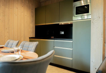 Modern kitchen and dining table at Ecolodge l 2 Slaapkamers with Semois view, Hameau de la Semois, Belgium.